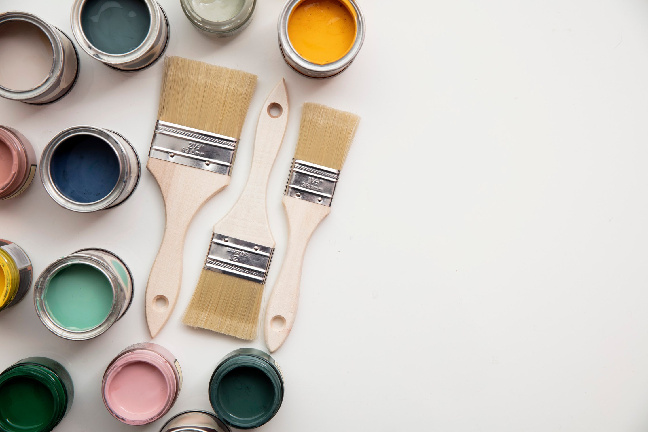 Overhead View of Paint Brushes with Colored Paint Cans